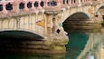 A stone bridge with ornate carvings and colorful mosaic tiles.