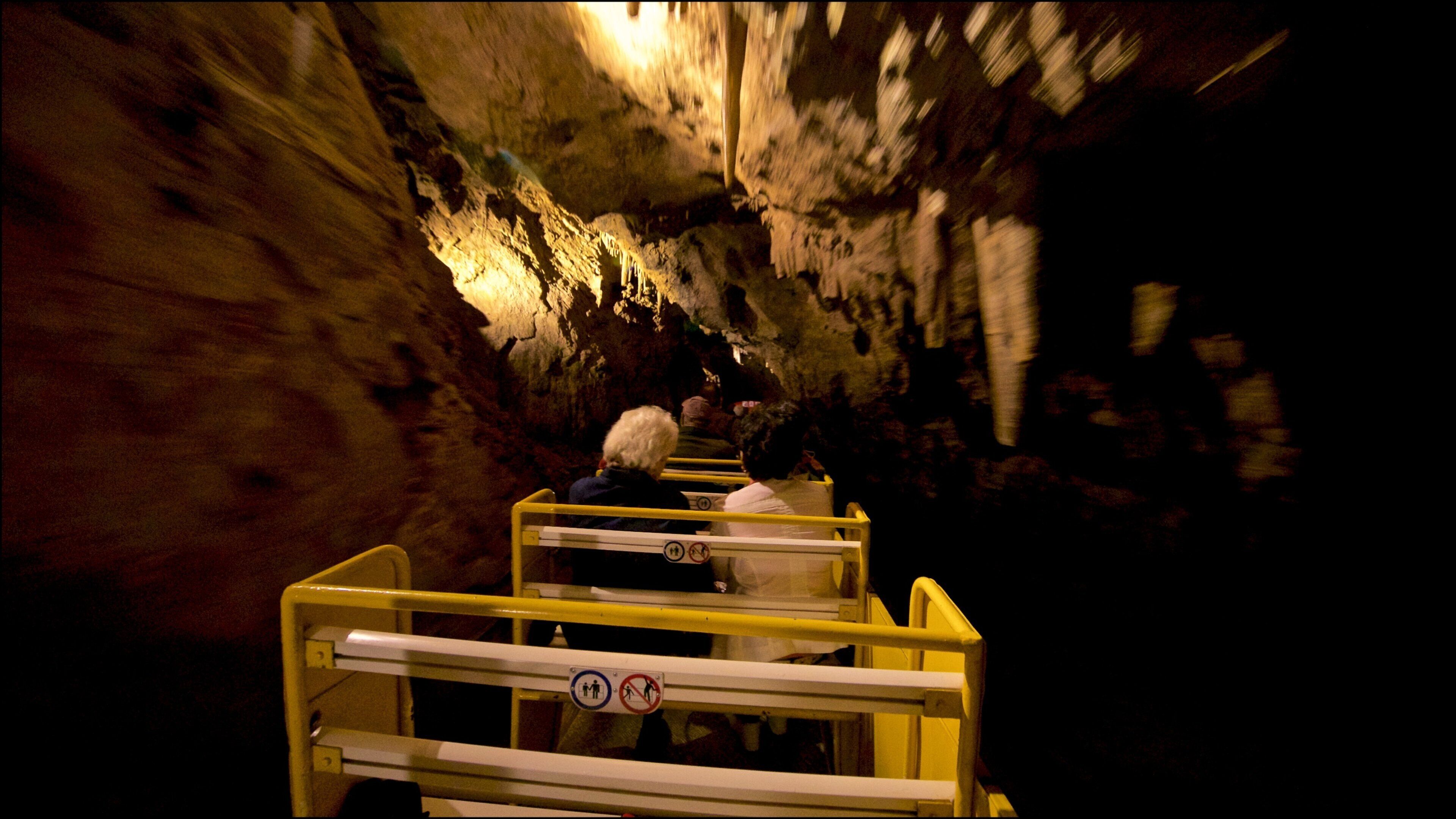 Betharram Caves showing railway items and caves as well as a small group of people
