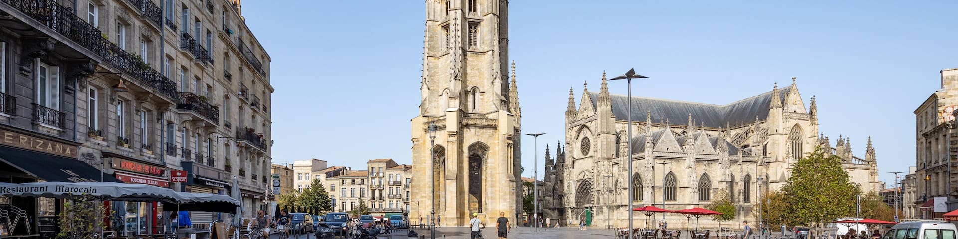A tall Gothic cathedral with intricate spires and a large, ornate facade.