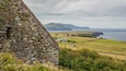 Irish Famine Cottages featuring heritage elements and general coastal views