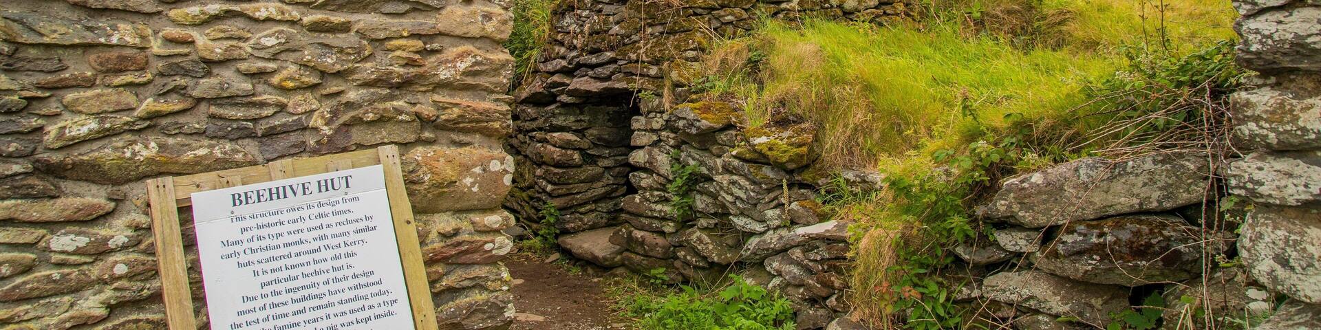 Irish Famine Cottages which includes signage, heritage elements and building ruins
