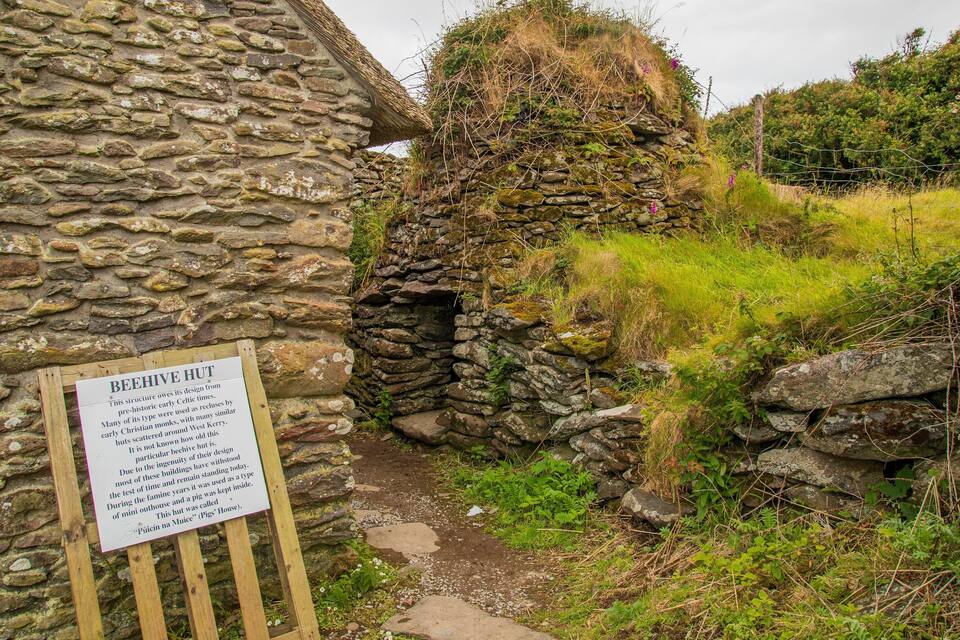 A stone hut with a sign explaining its historical significance.