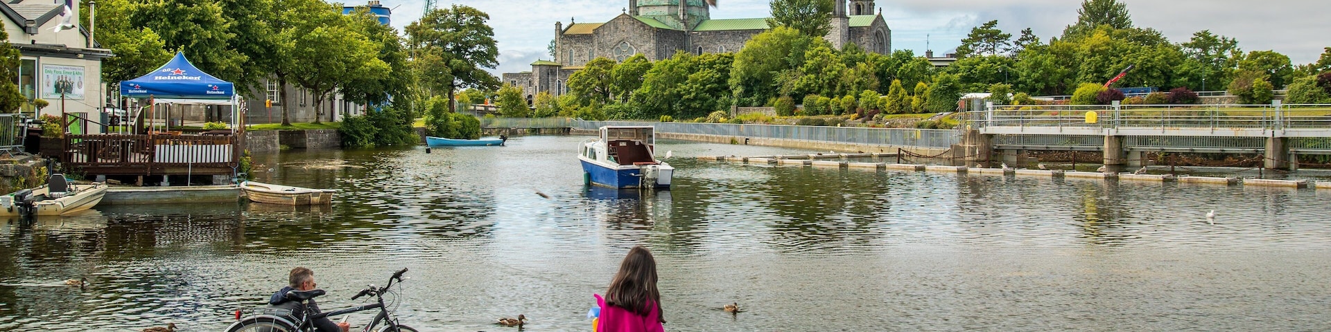 Riverside Walk showing cuddly or friendly animals and a bay or harbor as well as a family