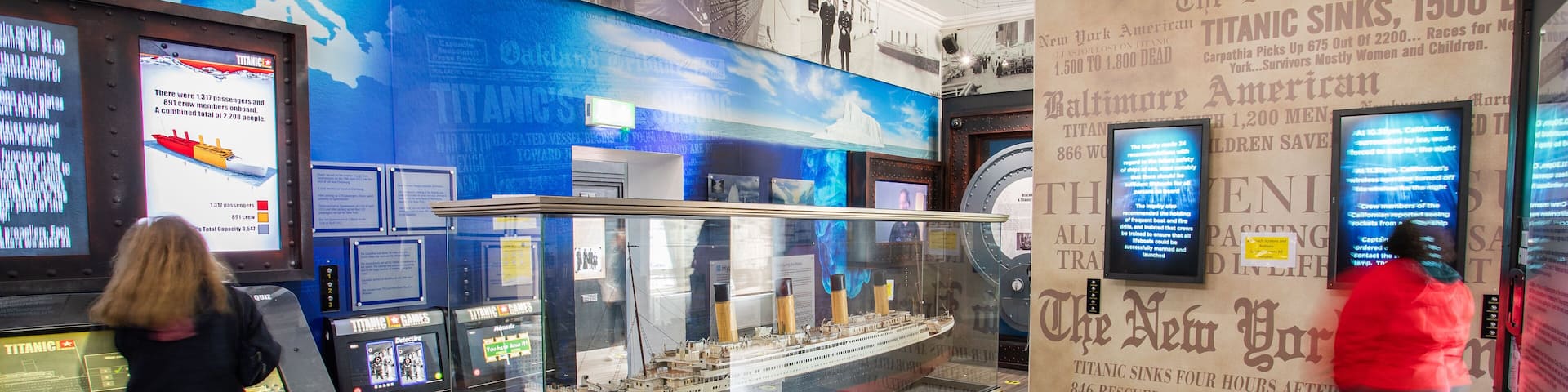 An exhibit with a Titanic model, informational displays, and historical photos.