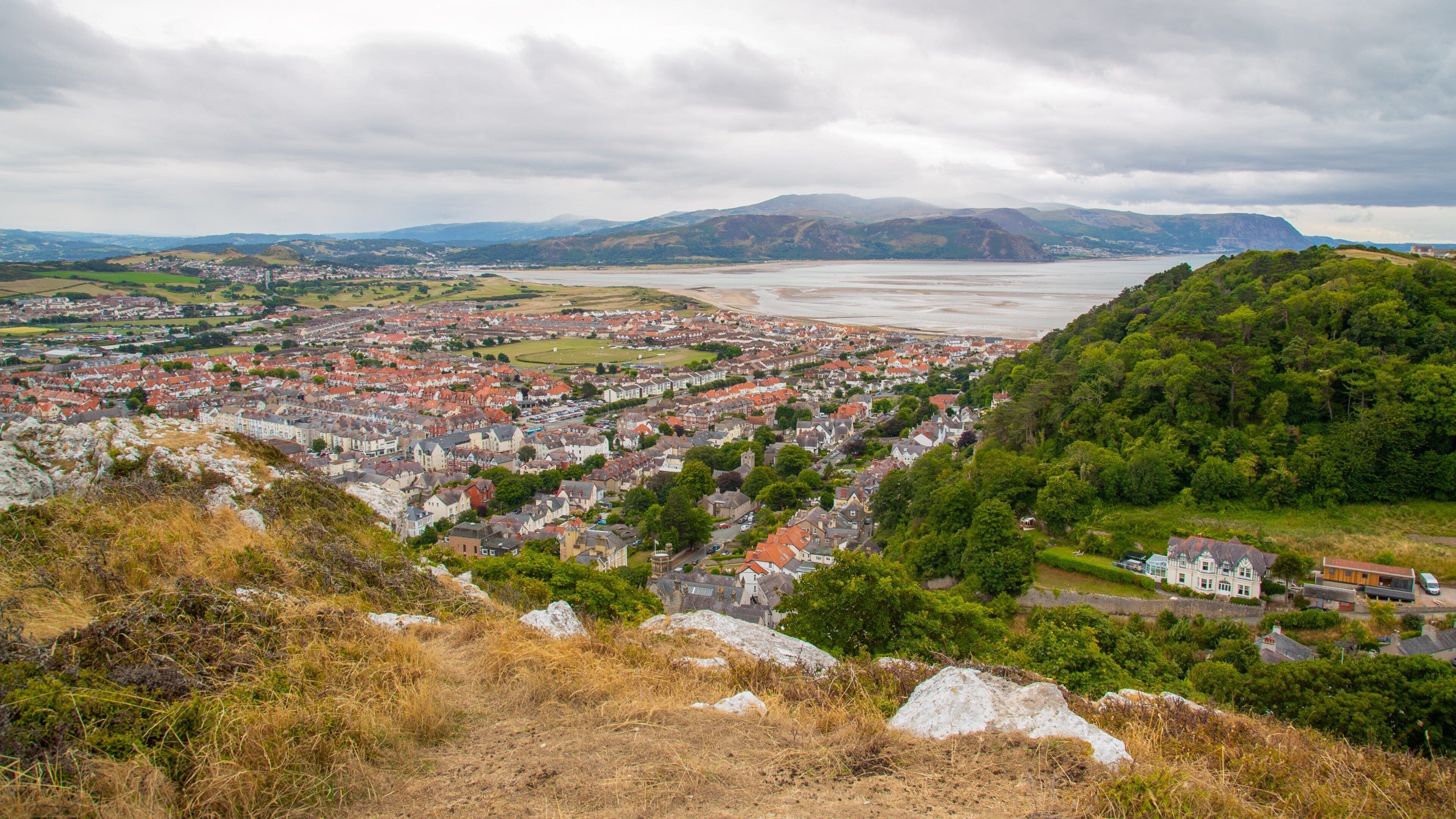 Pen-y-Dinas Hillfort featuring a coastal town, landscape views and general coastal views