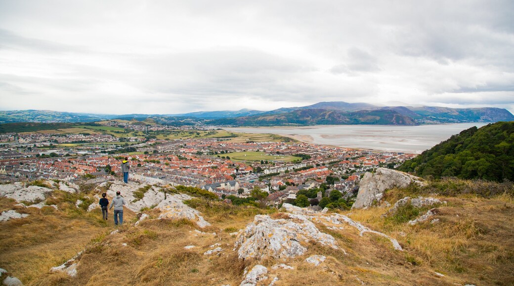 Pen-y-Dinas Hillfort featuring a coastal town and landscape views as well as a couple