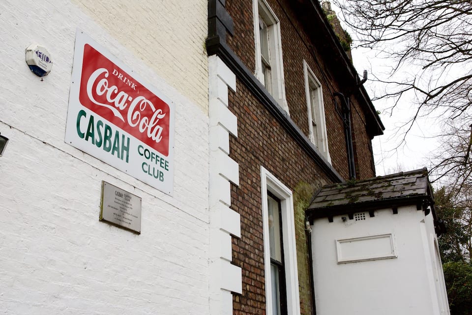 A building with a Coca-Cola sign and a Casbah Coffee Club sign.