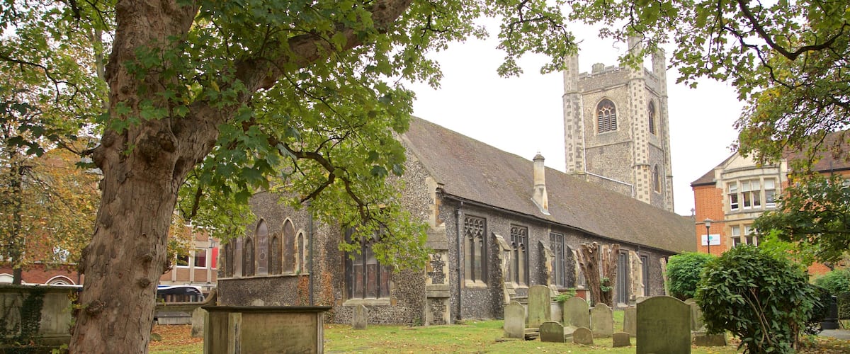 St. Laurence Church featuring heritage architecture, a cemetery and autumn leaves
