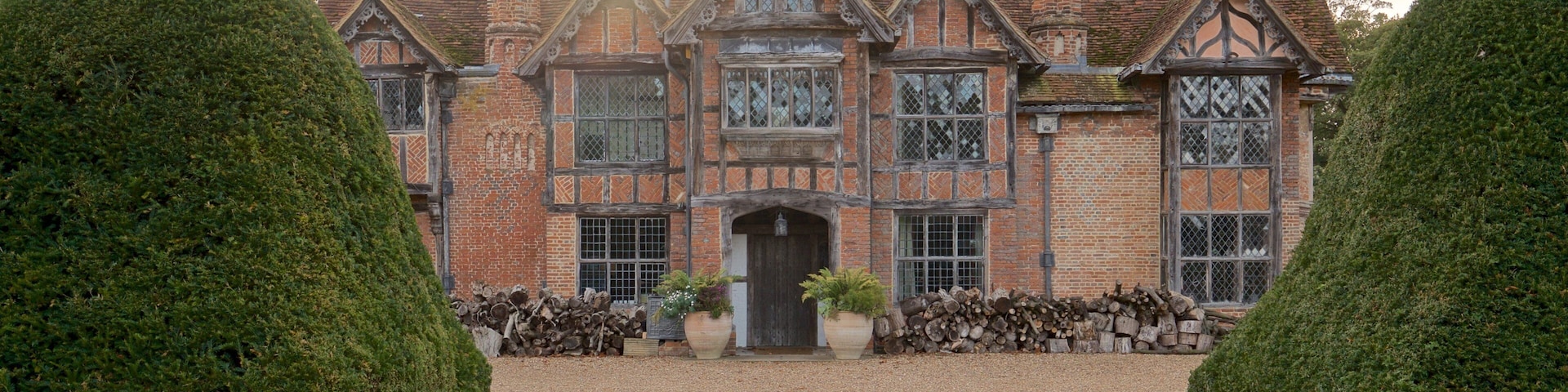 A large, historic building with a symmetrical facade, large windows, and a central entrance.