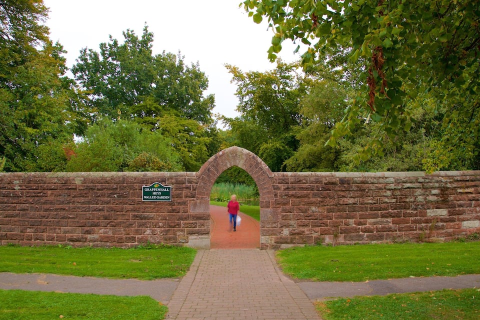 A brick archway leading to a garden with a sign reading "Grappenhall Heys Walled Garden".
