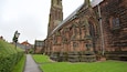 A historic church with twin towers and a paved pathway.