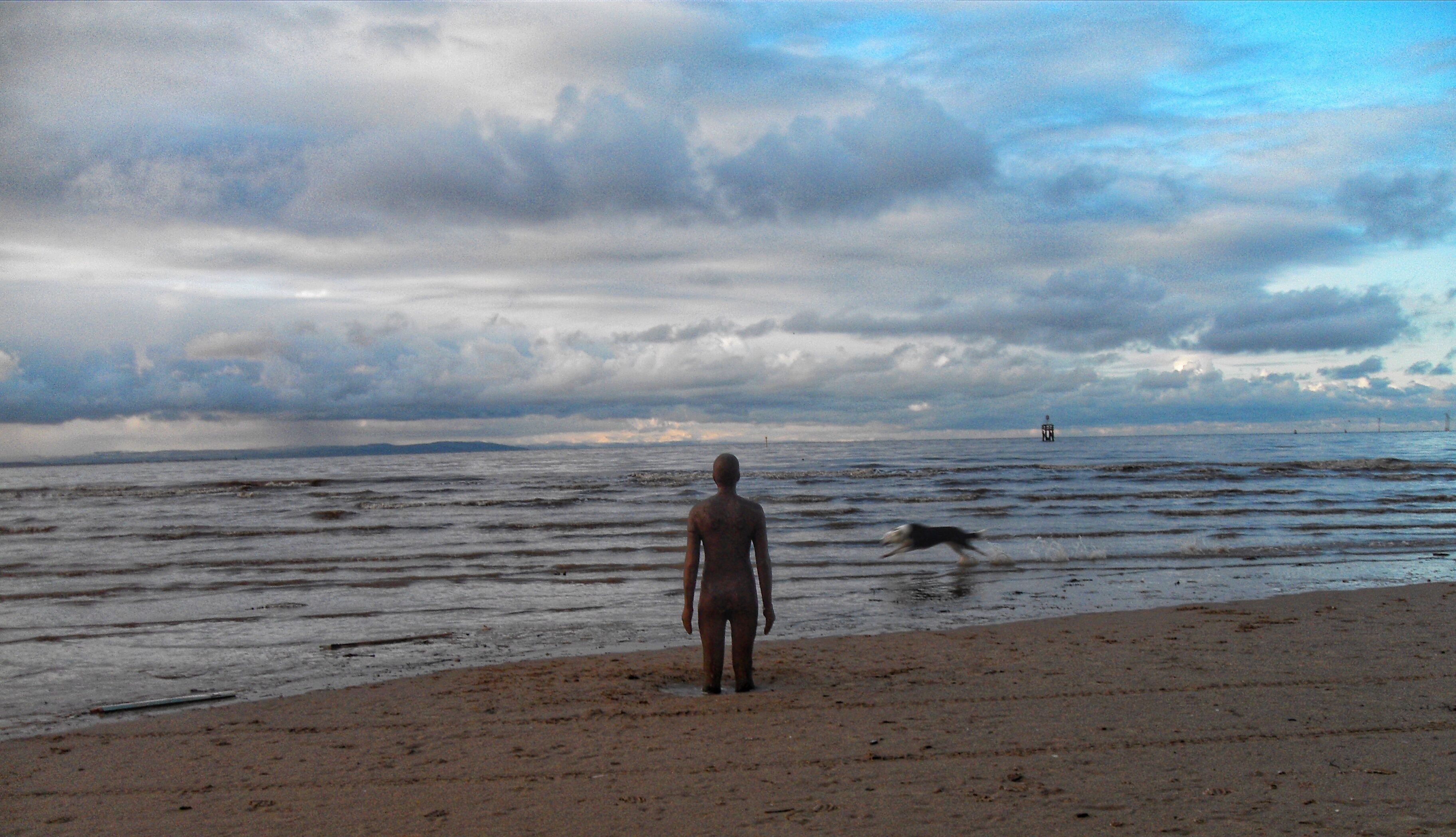 Gormley & the running dog.
Originally taking an image of the Anthony Gormley statue & the sky then a a running dog appeared in my view finder.
Crosby beach, Merseyside. 