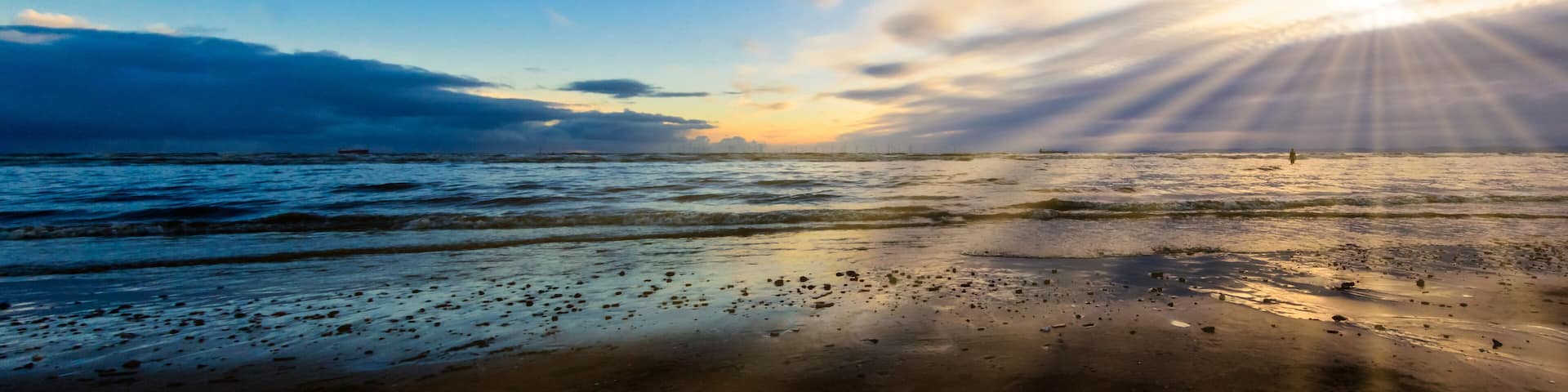 Sunset on Crosby Beach in winter, Crosby, Liverpool, United Kingdom