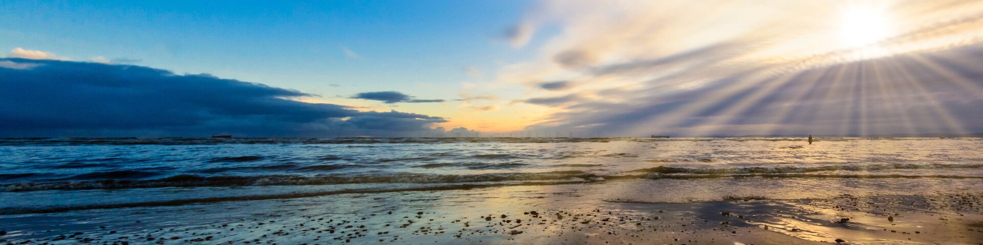 Sunset on Crosby Beach in winter, Crosby, Liverpool, United Kingdom