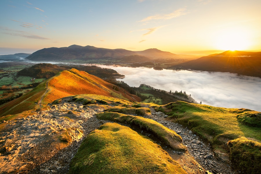 Beautiful Sunrise Overlooking Derwentwater From Catbells On A Sunny Calm Morning With Cloud Inversion Mist Over Lake. Lake District National Park, UK.