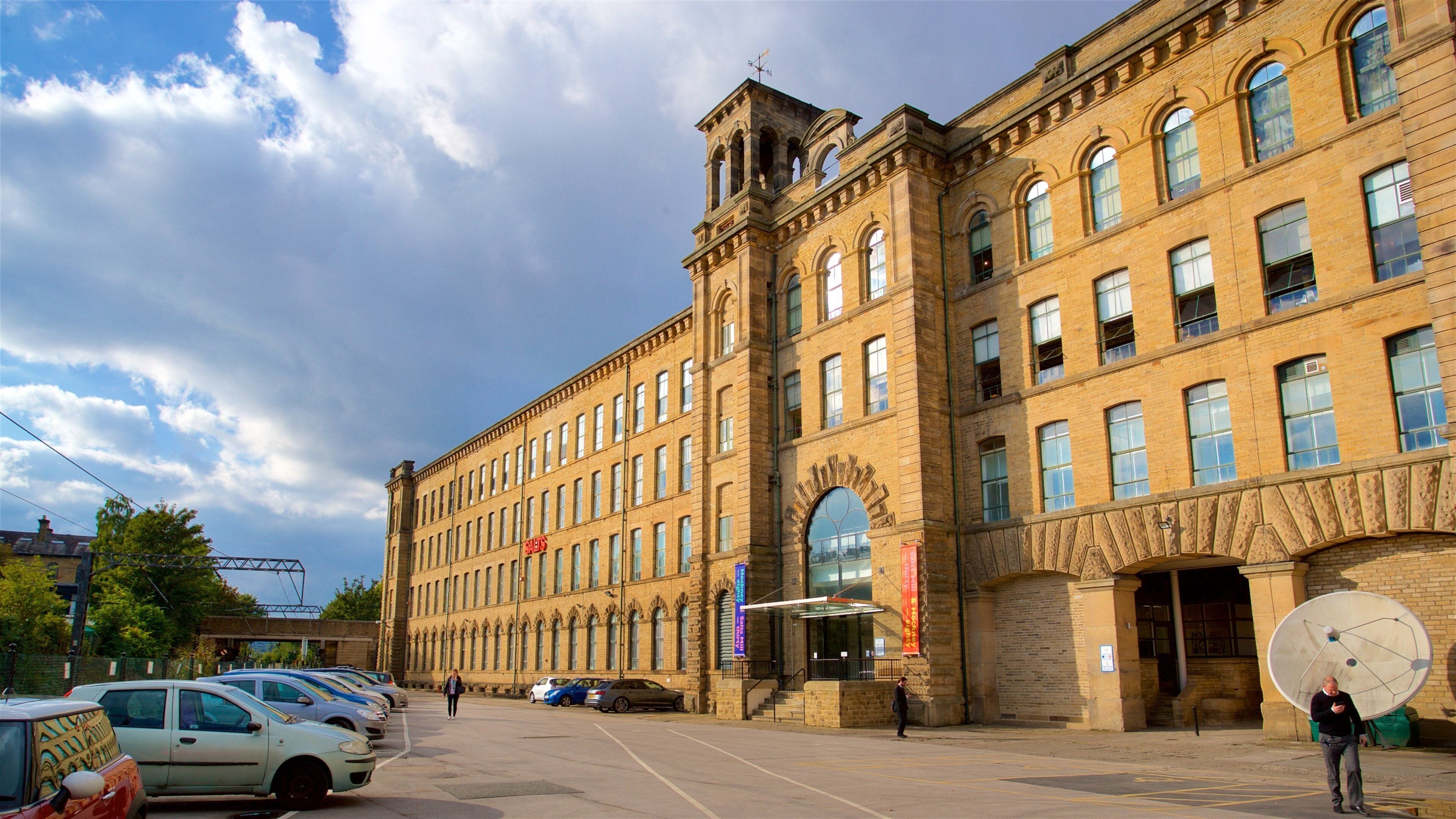 A large brick building with multiple windows and a prominent tower.