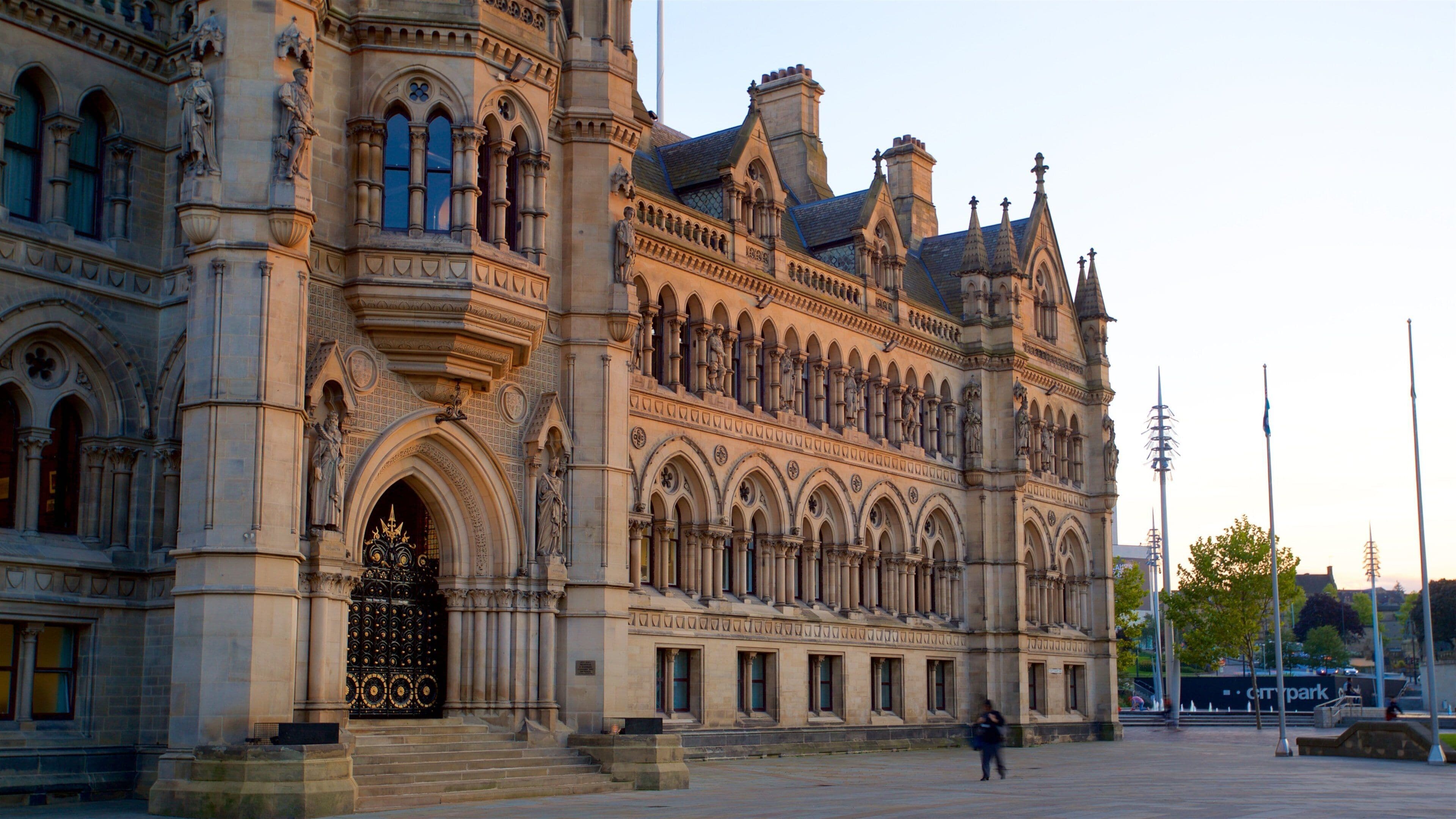 A historic building with ornate Gothic architecture, featuring pointed arches, detailed stonework, and statues.