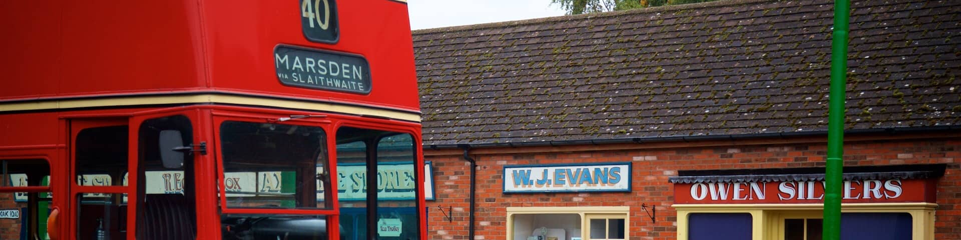 A red and cream bus with the number 40 and route 'MARSDEN' on it, parked in front of a shop named 'W.J. EVANS'.