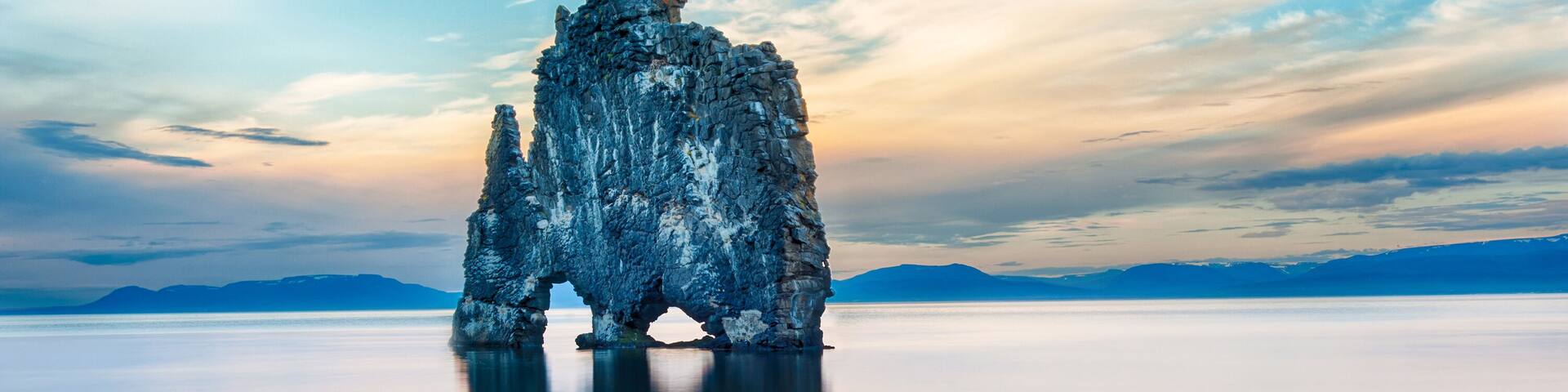 Hvitserkur is a spectacular rock in the sea on the Northern coast of Iceland. Legends say it is a petrified troll. On this photo Hvitserkur reflects in the sea water after the midnight sunset