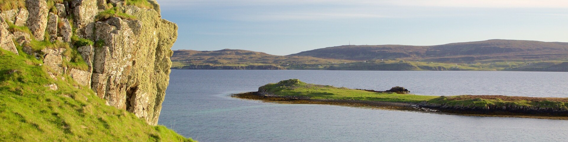 Isle of Skye which includes rocky coastline and tranquil scenes