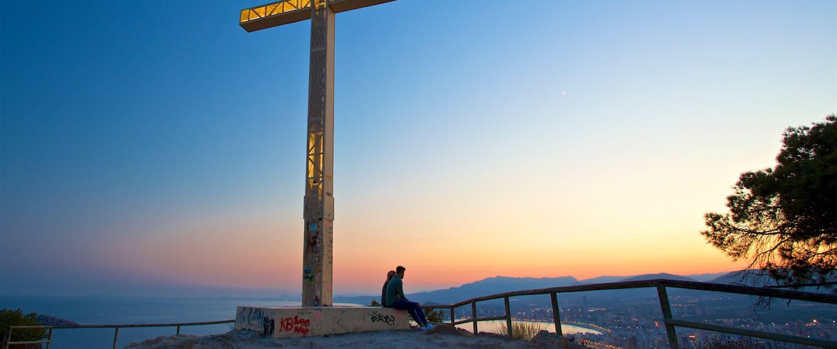 La Cruz Benidorm which includes a sunset, religious elements and landscape views