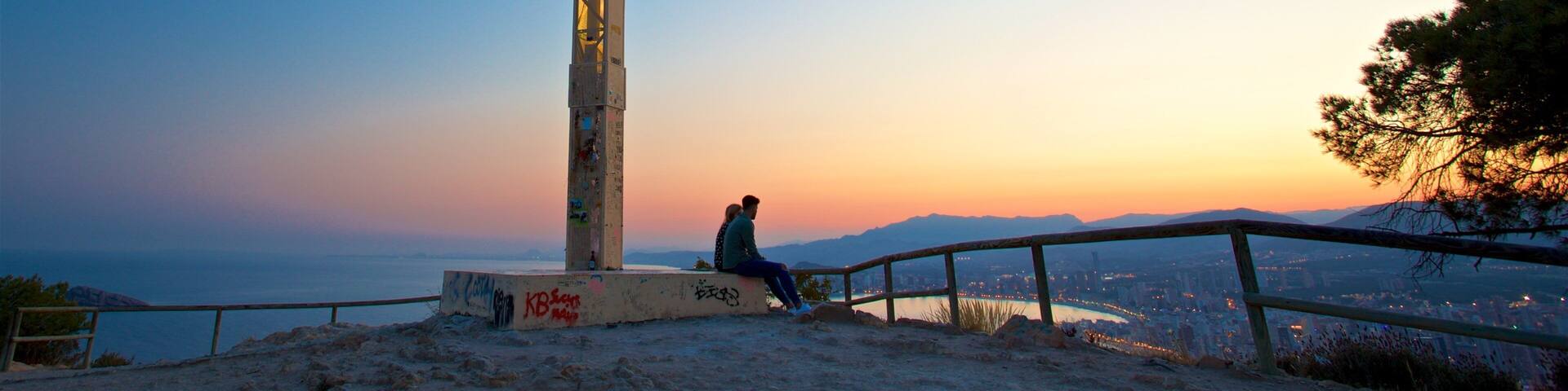 La Cruz Benidorm which includes a sunset, religious elements and landscape views