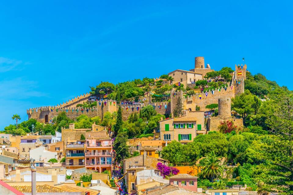 A historic hilltop town with medieval architecture, including a castle and fortified walls.