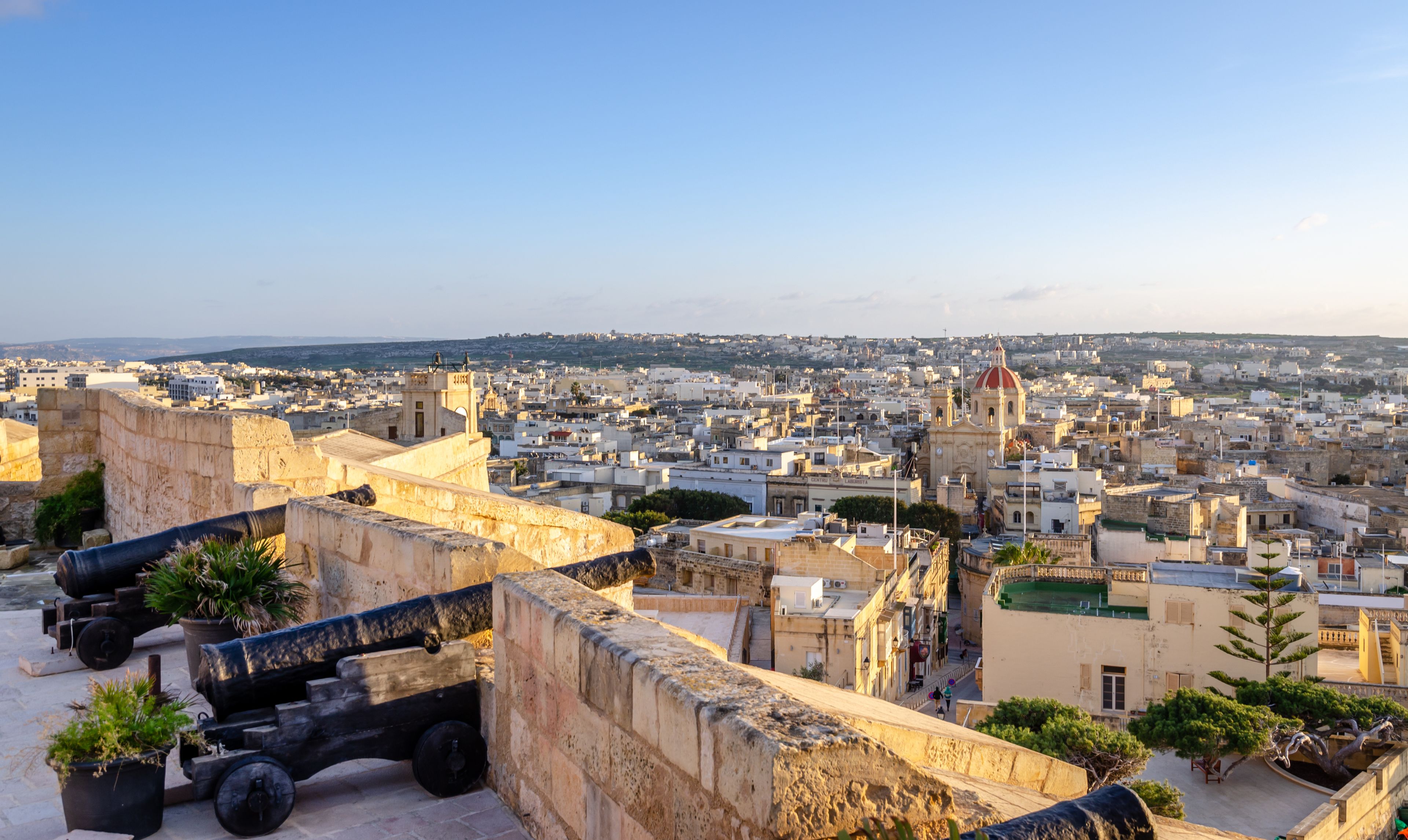 Fortified buildings and the old moat within the citadel with views towards the city and Church, Victoria, Gozo, Malta, Europe, January 11, 2022.