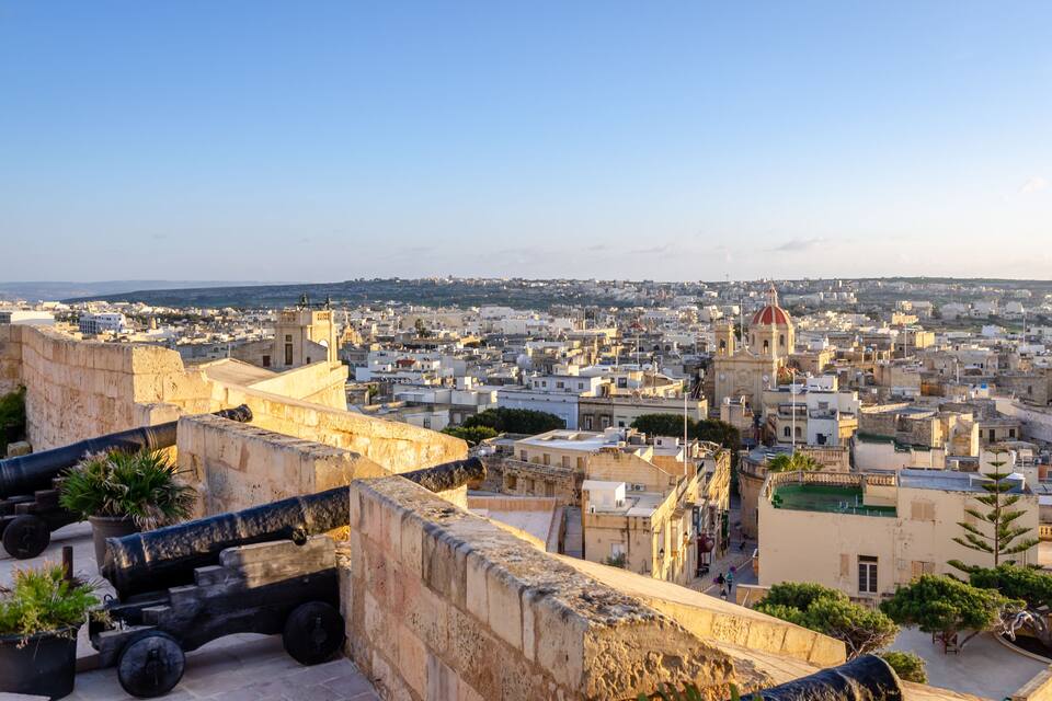 Fortified buildings and the old moat within the citadel with views towards the city and Church, Victoria, Gozo, Malta, Europe, January 11, 2022.