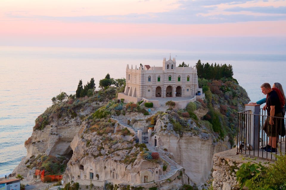 A castle on a cliff overlooking the sea.