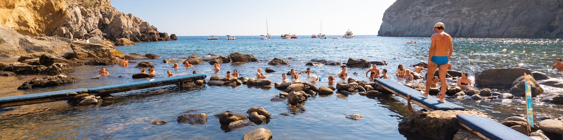Bay of Sorgeto showing general coastal views and swimming as well as an individual male