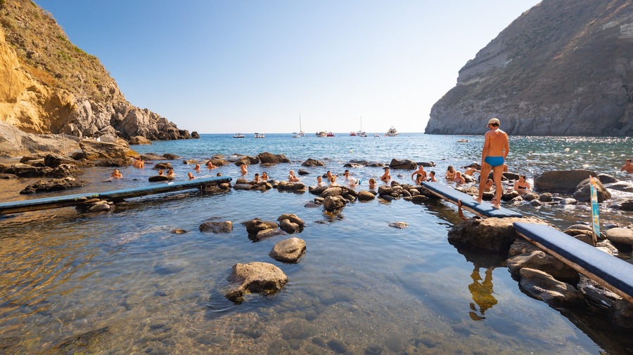 Bay of Sorgeto showing general coastal views and swimming as well as an individual male