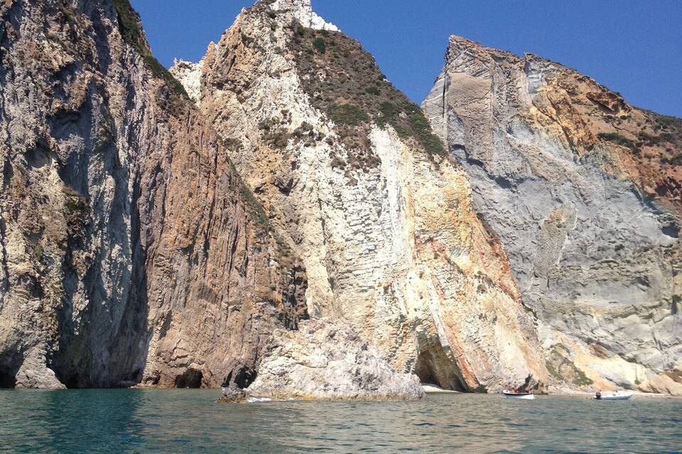 A rocky coastline with clear blue water.