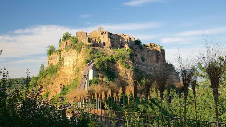 A historic castle perched on a cliff with a staircase leading up to it.