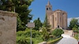Une église historique dotée d’un clocher, entourée d’une végétation luxuriante et sur laquelle on peut lire l’inscription « Villa de Parco ».
