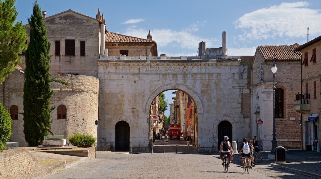 Arco di Augusto som viser kulturarv og sykling i tillegg til par