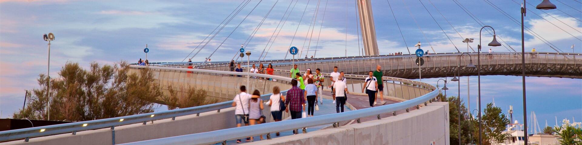 Ponte del Mare featuring a sunset and a bridge as well as a small group of people