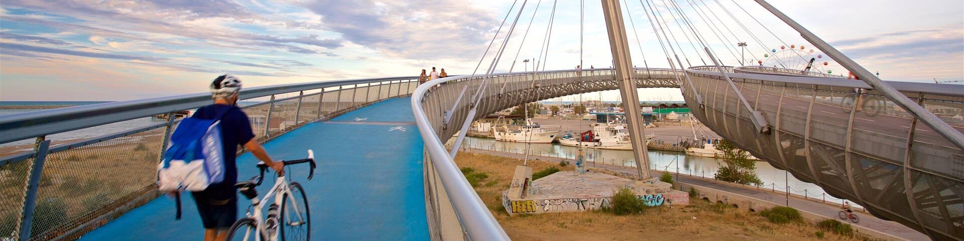 Ponte del Mare showing cycling, a sunset and a bridge