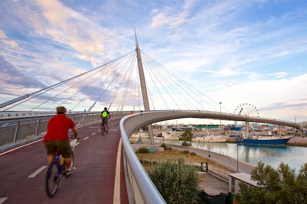 Ponte del Mare showing a bridge, a sunset and cycling