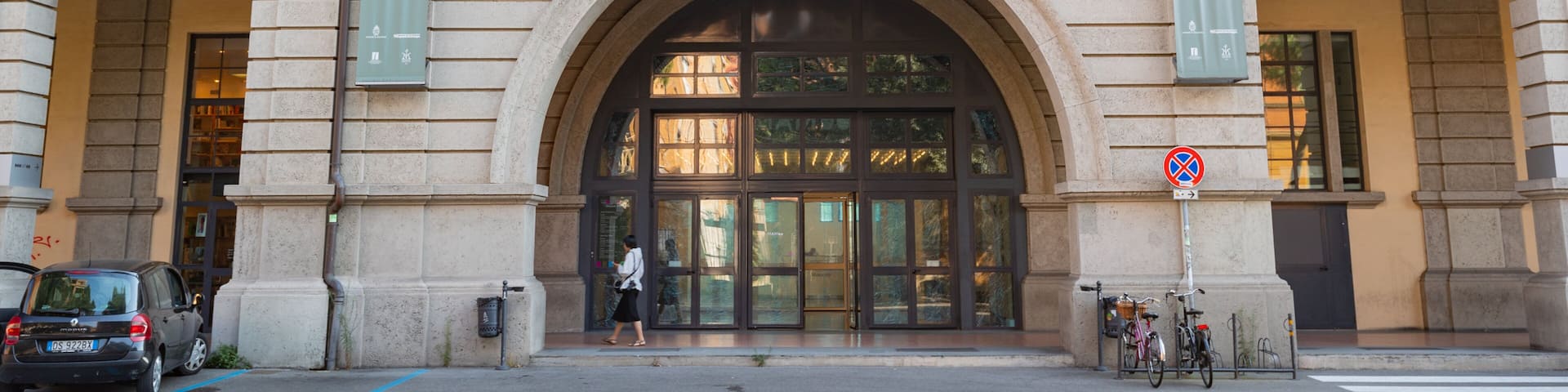 A building with large arched windows and a sign reading "MAMBO".