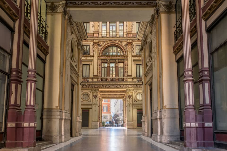 An ornate building with a grand entrance, large columns, and intricate architectural details.