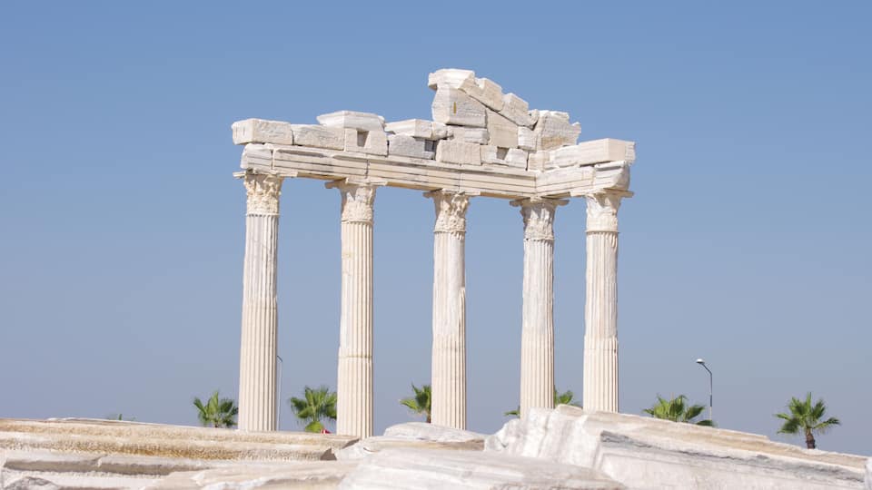 Ancient white marble columns of a classical Greek temple.