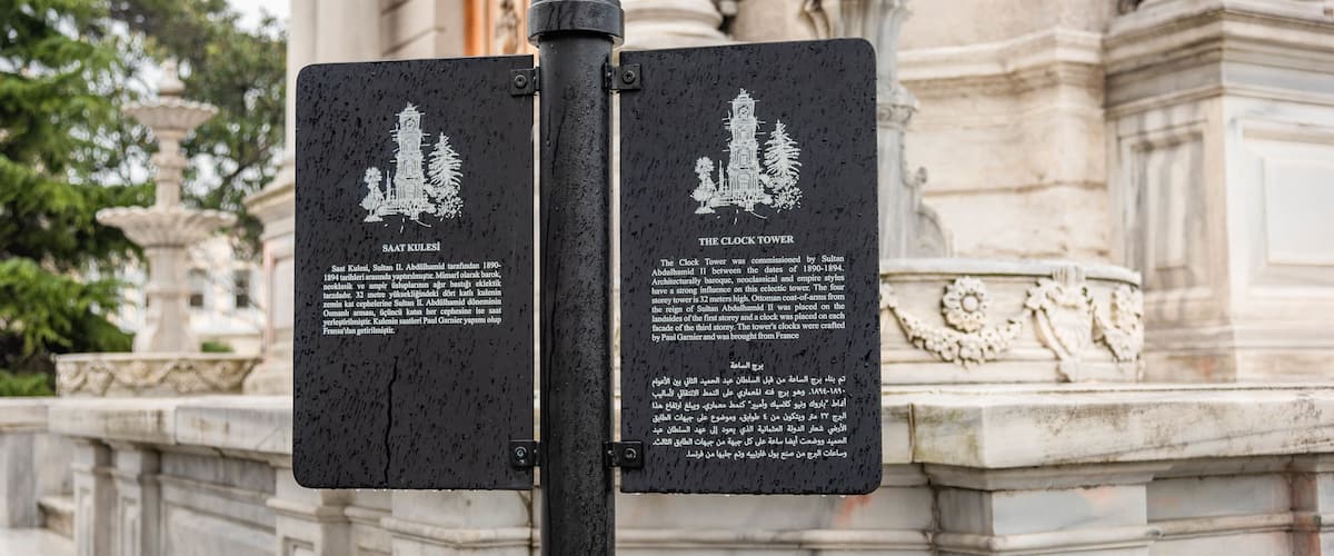 Dolmabahce Clock Tower which includes signage and heritage elements