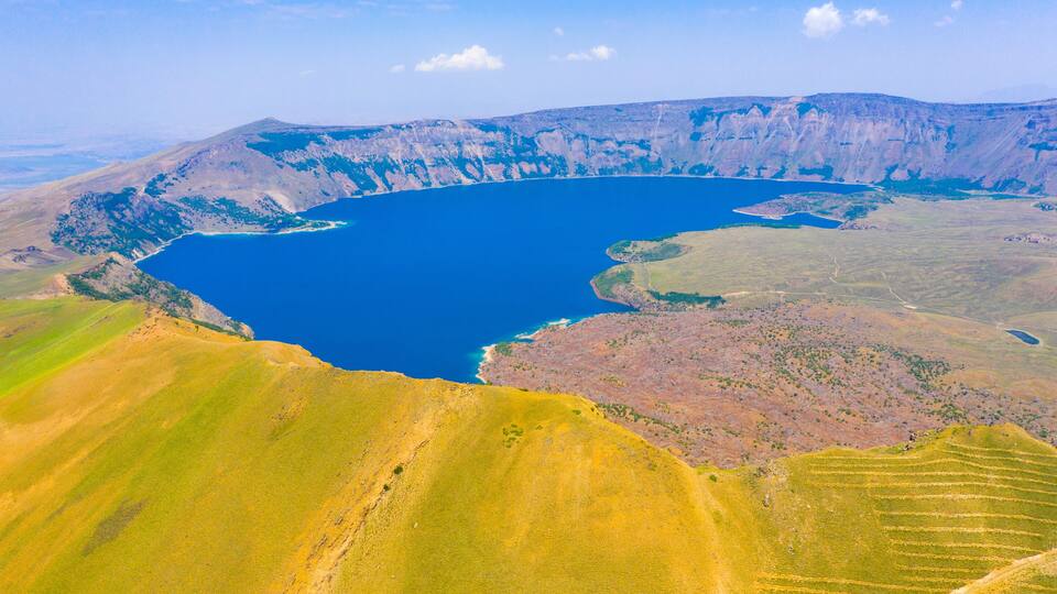 A large lake surrounded by hills and mountains.