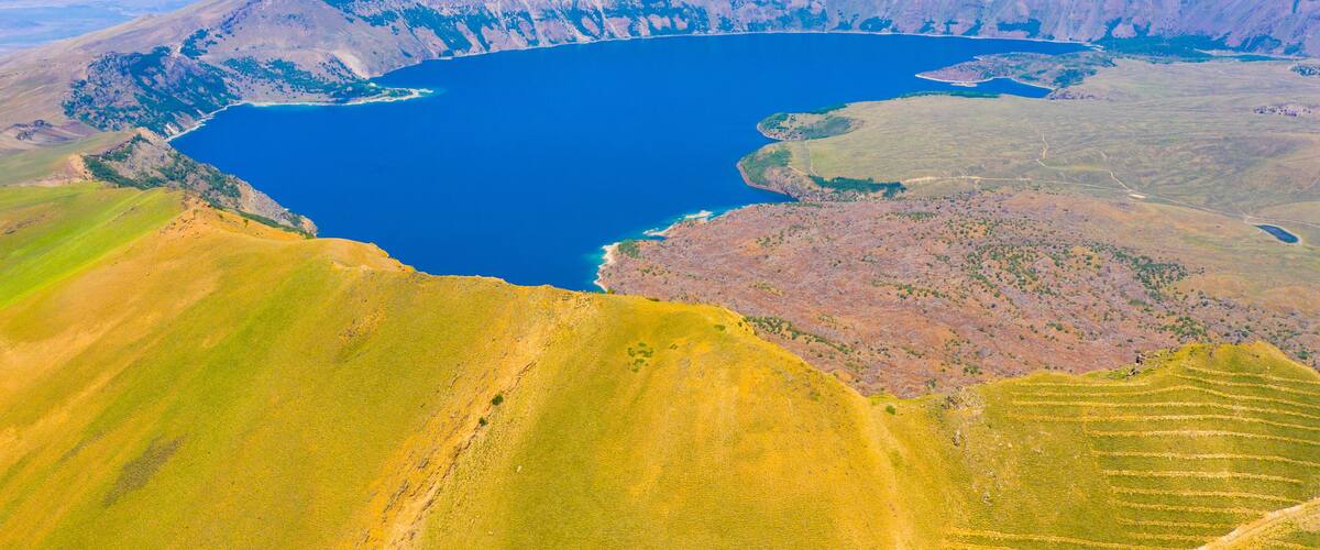 A large lake surrounded by hills and mountains.