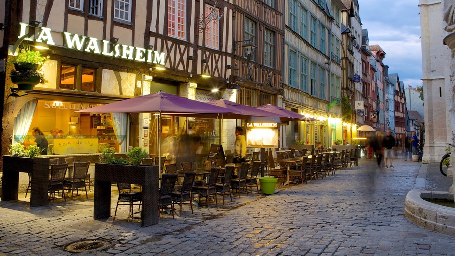 Rouen showing outdoor eating, a small town or village and night scenes