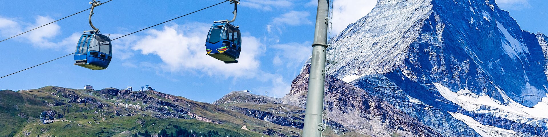 Cable car with ski slope in mountains near Zermatt, Switzerland. Swiss Alps with Matterhorn, train and ski lift.