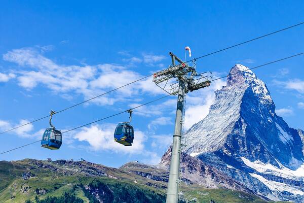 Cable car with ski slope in mountains near Zermatt, Switzerland. Swiss Alps with Matterhorn, train and ski lift.