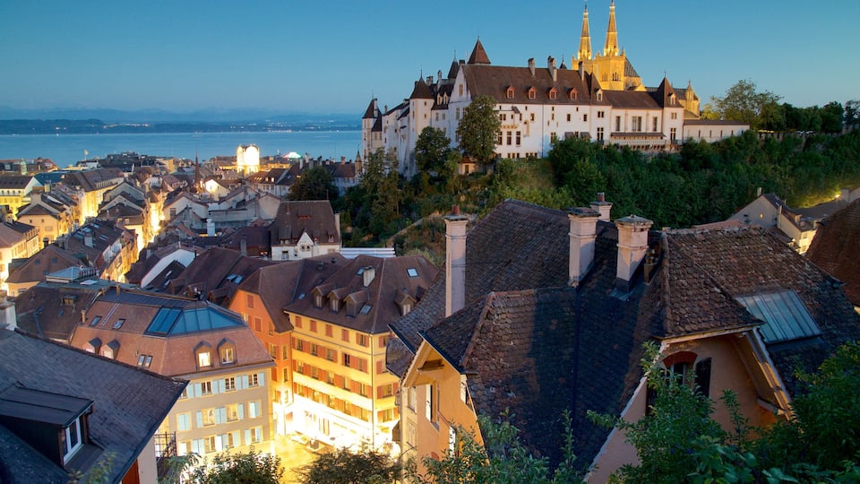 A historic town with a prominent castle overlooking a river.
