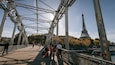 Passerelle Debilly which includes a bridge and a sunset as well as a small group of people